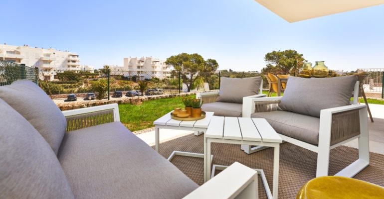 A new build apartment in Cala d'Or with a balcony and a view of the city.