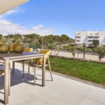 A new build apartment in Cala d'or with a balcony overlooking a grassy area.