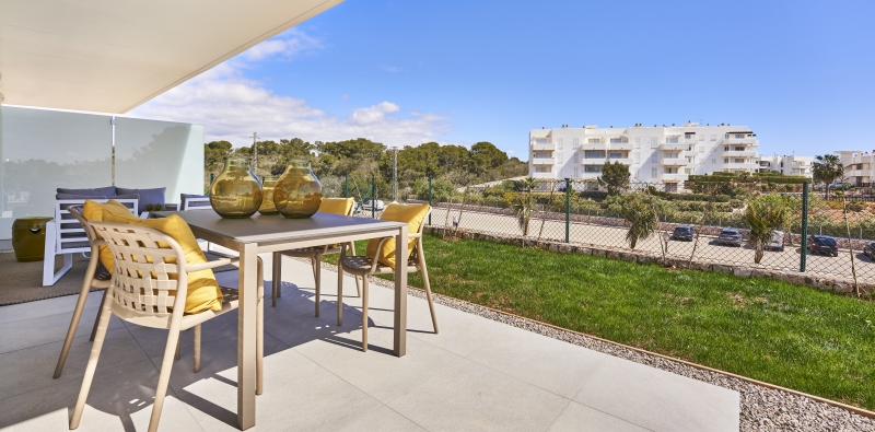 A new build apartment in Cala d'or with a balcony overlooking a grassy area.