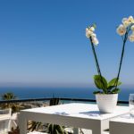 Alicante property for sale with a white table and a vase of flowers.