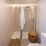A small bathroom with a toilet and shower stall in an Alicante New Build Apartment.