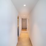 A white-walled hallway with a white floor in a Gran Alicante new build apartment.