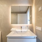 Alicante property for sale with a modern bathroom featuring a white sink and mirror.