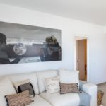 A white couch in a living room in a new build apartment for sale in Alicante.