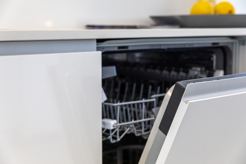 A dishwasher is open in a kitchen of a new build apartment for sale in Alicante.