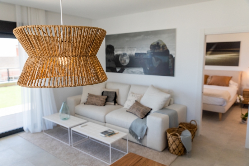 A New Build Apartment with a wicker hanging lamp.