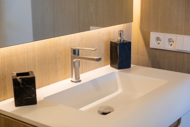 A modern bathroom with a sink and mirror in a Gran Alicante New build apartment.