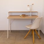 A white desk and chair in a small room available for sale in Alicante.