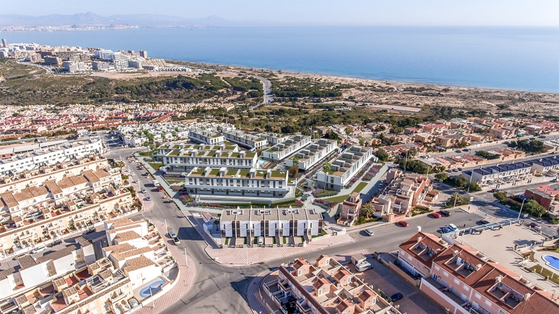 An affordable aerial view of a town by the ocean including Alicante New Build Apartments for sale.
