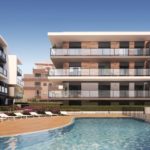 A rendering of a new build apartment complex with a swimming pool for sale in Alicante.