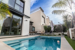 A modern Orihuela Costa villa with a swimming pool in the backyard is for sale.