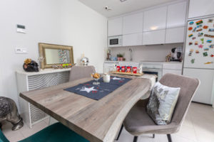 A small kitchen with a dining table and chairs in an Orihuela Costa villa.