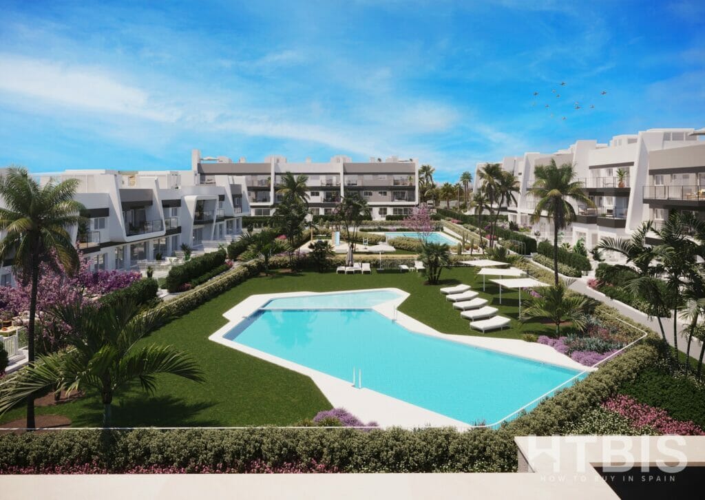 An Alicante New Build Apartment complex with a swimming pool and lawn.