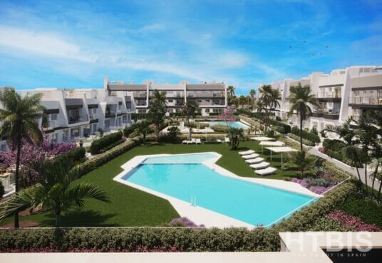 An Alicante New Build Apartment complex with a swimming pool and lawn.