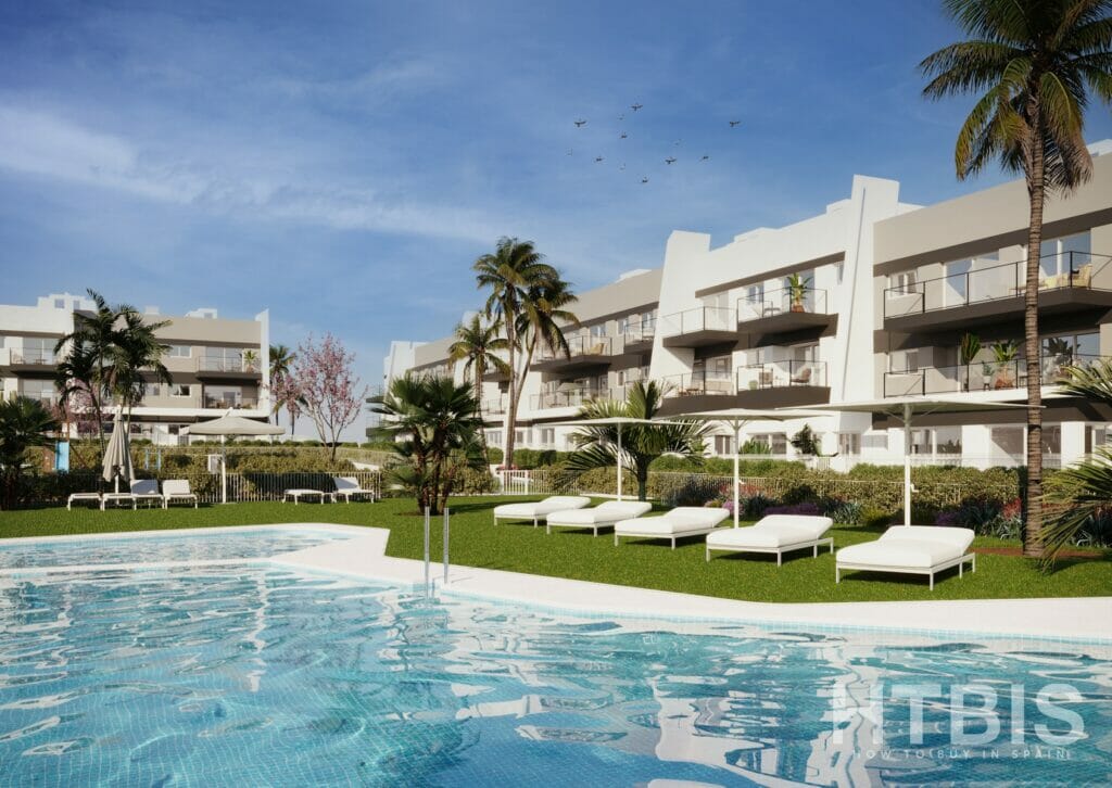 A rendering of a Gran Alicante new build apartment complex featuring a swimming pool and lounge chairs.