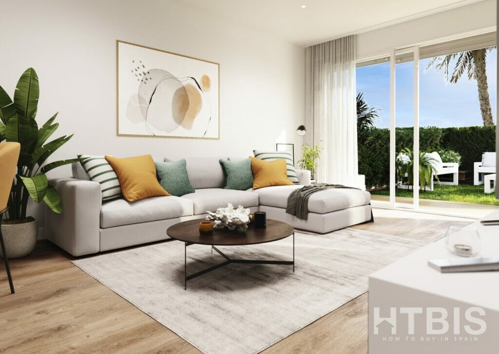 A living room in a Gran Alicante New Build Apartment, with a white couch and a coffee table.