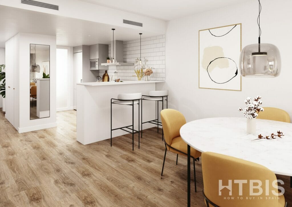 A white kitchen and dining room with yellow chairs in a new build apartment in Gran Alicante.