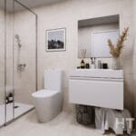 A bathroom in a Gran Alicante new build apartment with a toilet, sink, and shower.