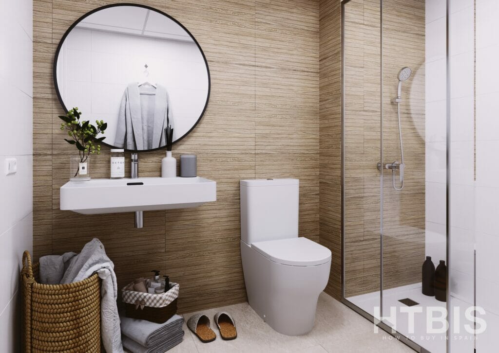 A bathroom in the Gran Alicante new build apartment with a toilet, sink, and shower.