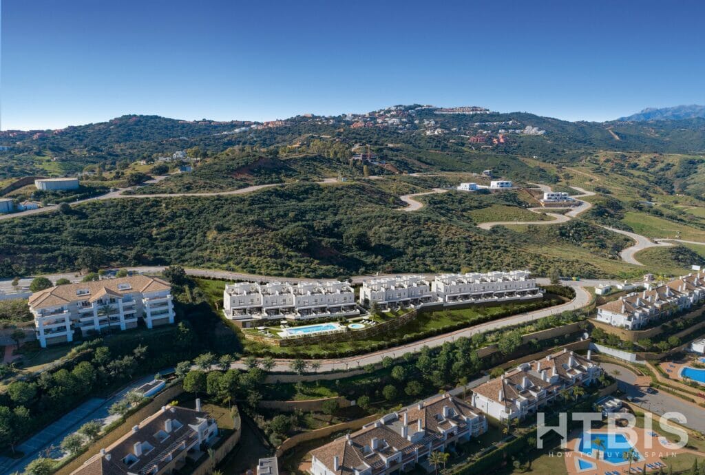 An aerial view of a new build townhouse complex in the mountains at Belaria La Cala resort.