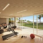 A gym room with a view of the ocean in a stunning Alicante New Build Apartment.