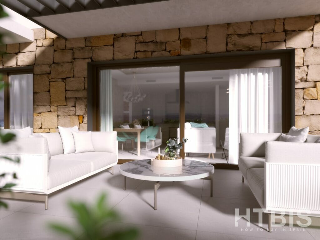 A rendering of an apartment patio in Malaga with white furniture and a stone wall.