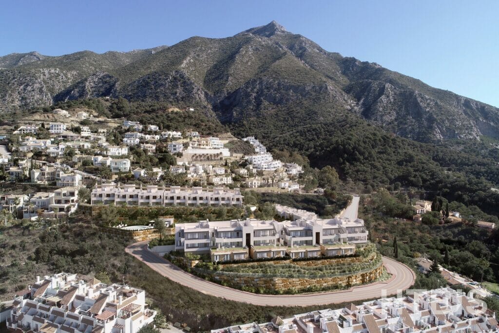 An aerial view of an apartment complex in Malaga, nestled in the mountains.