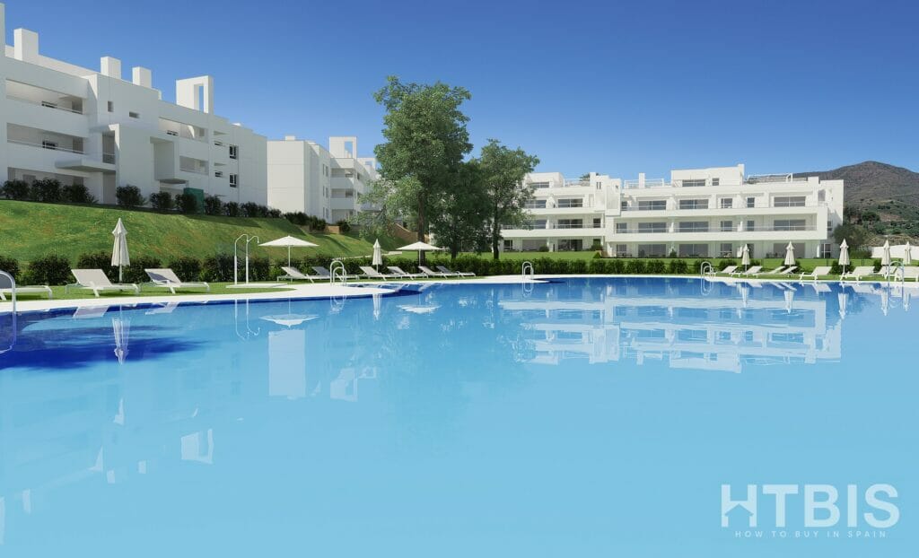 An image of a Marbella New Build apartment complex with a swimming pool.