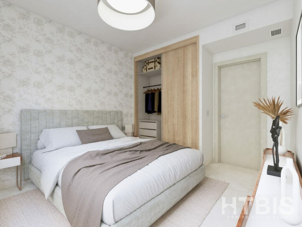 A bedroom with a bed and a closet in a Marbella New Build apartment.
