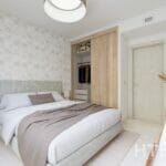 A bedroom with a bed and a closet in a Marbella New Build apartment.