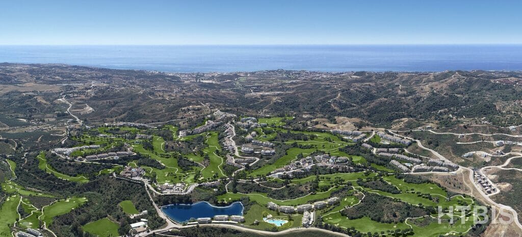 An aerial view of a golf course near the ocean, close to a New Build Apartment Mijas.