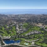 An aerial view of a golf course near the ocean, close to a New Build Apartment Mijas.