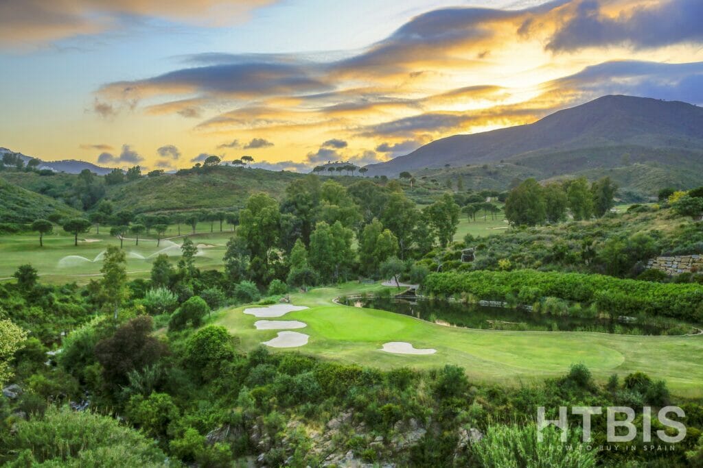 A golf course in the mountains at New Build apartment Mijas at sunset.