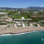 An aerial view of a resort, the Estepona golf course, and the beach.