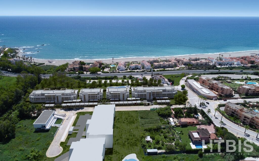 An aerial view of an apartment complex near the Estepona Golf Course and the beach.