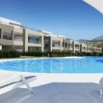 A 3D rendering of an apartment complex with a swimming pool near the Estepona Golf Course.