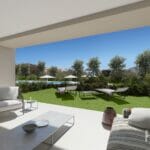 A rendering of an apartment in Estepona with an outdoor living area including furniture and a view of a golf course.