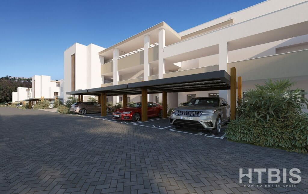 A rendering of an Estepona apartment complex with cars parked in front of it.
