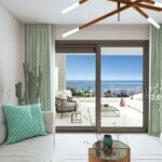 A living room in an apartment with a view of the ocean and the Estepona golf course.