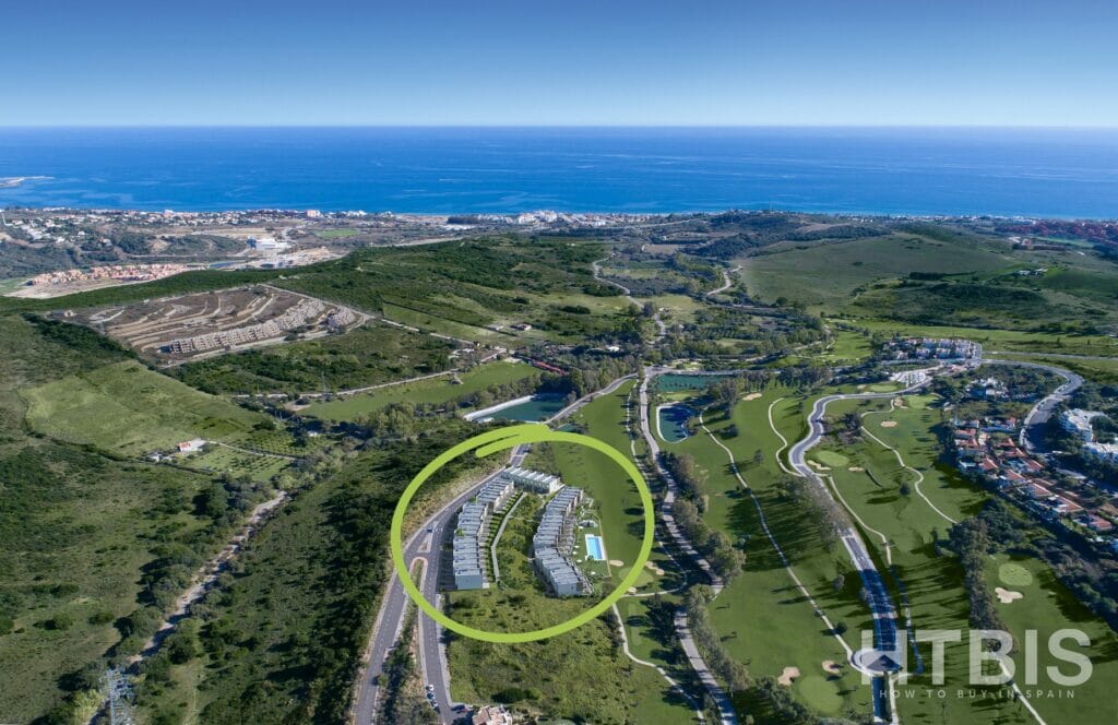 An aerial view of the Estepona Golf Course, townhouse, and the ocean.