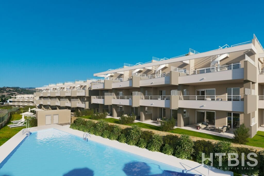 An apartment complex with a swimming pool near Estepona Golf Course.
