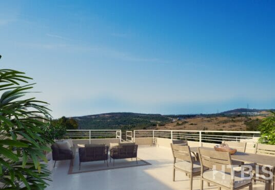 A balcony with furniture and a view of the mountains overlooking the Estepona Golf Course.