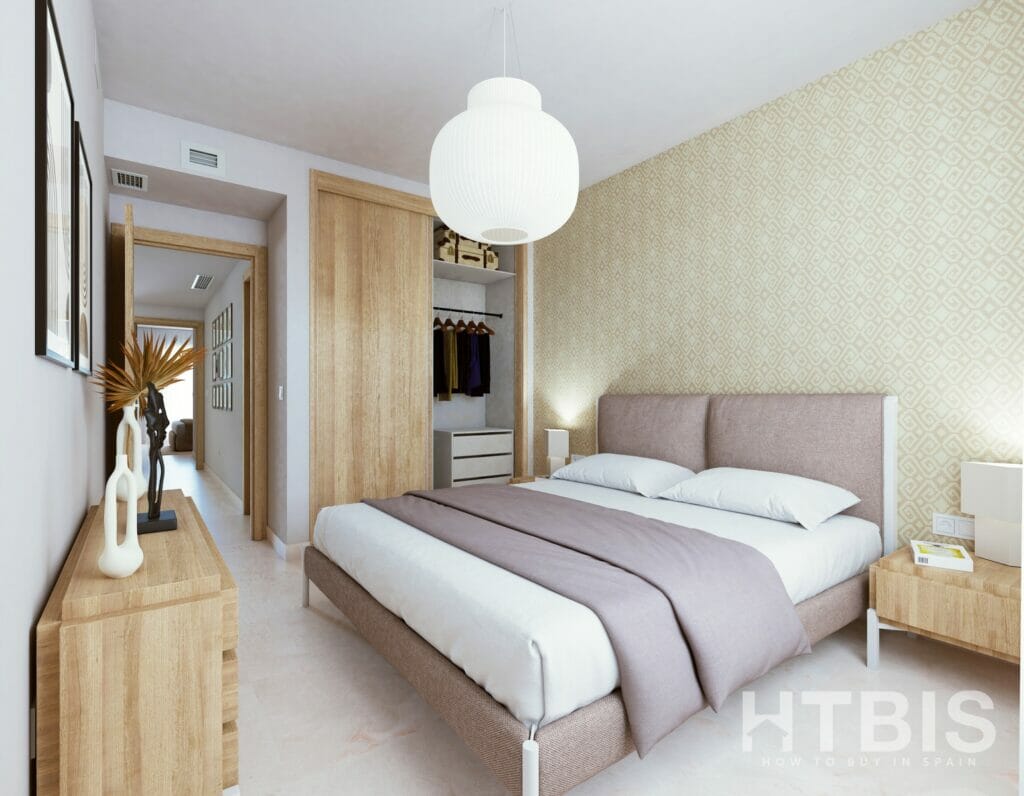 A bedroom with a bed and a dresser in an apartment overlooking the Estepona Golf Course.