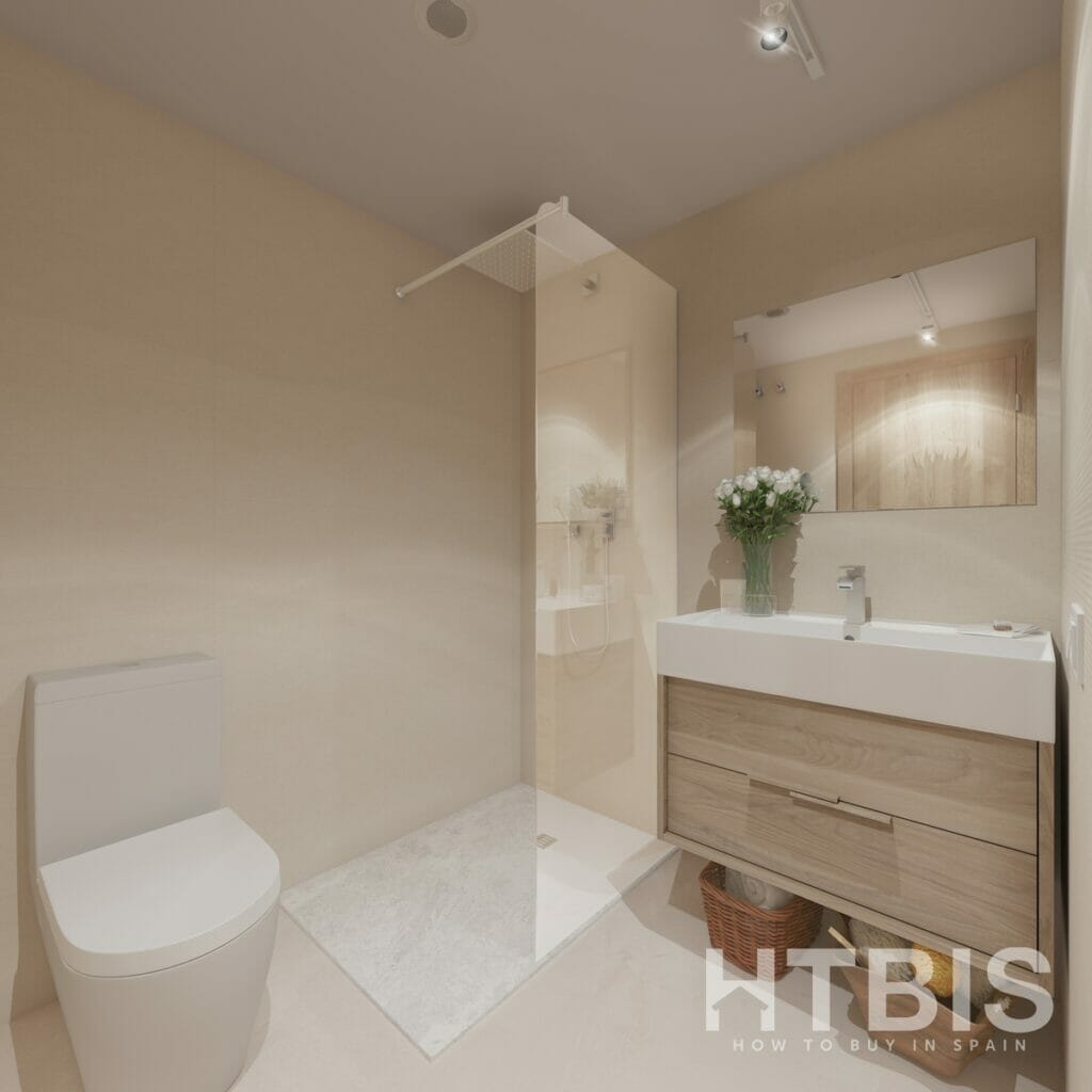 A bathroom in an apartment overlooking Estepona Golf Course, with a toilet, sink, and shower.
