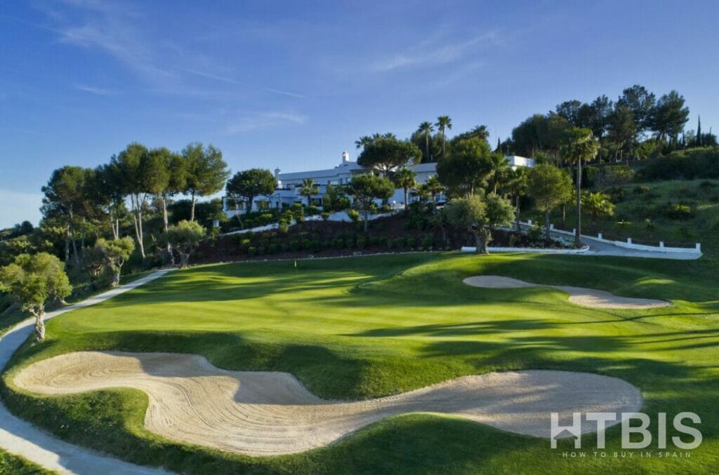 A golf course with sand bunkers and trees at Apartment Estepona.