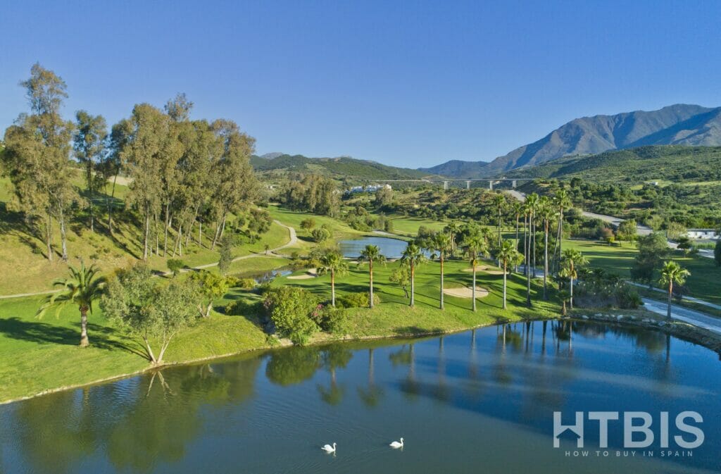 An aerial view of the Estepona Golf Course with mountains in the background.